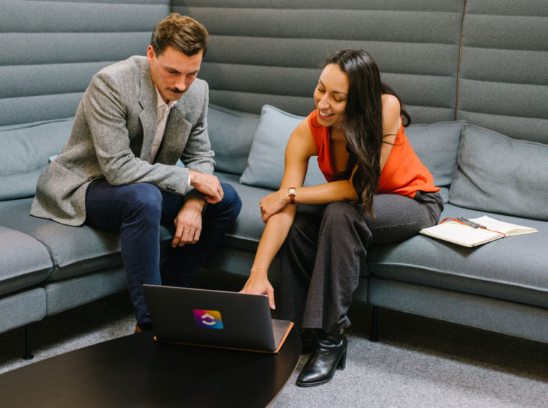 Photo de deux consultants suisses de ClickUp devant un ordinateur